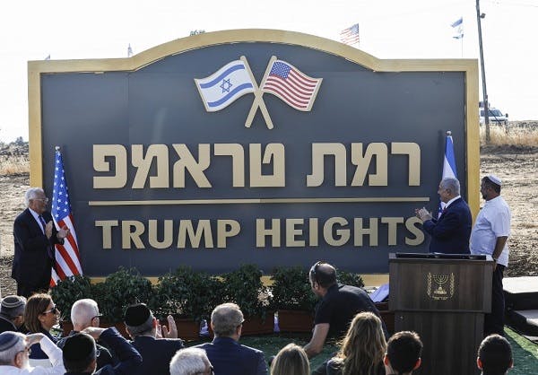 Israeli Prime Minister Benjamin Netanyahu (2nd-R) and US Ambassador to Israel David Friedman (L) applaud after unveiling the place-name sign for the new settlement of "Ramat Trump", or "Trump Heights" in English, named after the incumbent US President, during an official ceremony in the Israeli-annexed Golan Heights on June 16, 2019. - Netanyahu unveiled a "Trump Heights" sign to mark the site of the new settlement, which comes after the US president in late March recognised Israeli sovereignty over the part of the strategic plateau it seized from Syria in the 1967 Six-Day war. (Photo by Jalaa MAREY / AFP)