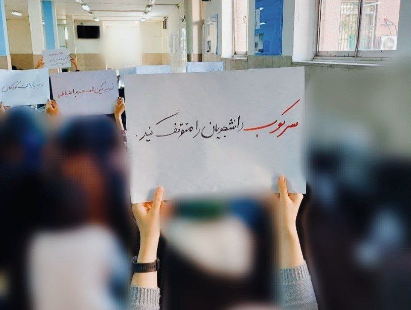 بر روی کاغذ در دست دانشجویان نوشته شده است: سرکوب دانشجویان را متوقف کنید