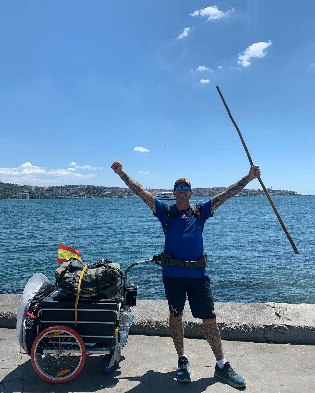 سانتیاگو سانچز، هوادار متعصب فوتبال و گردشگر اسپانیایی با وسایل سفر در شهر استانبول در کرانه دریا دستانش را به آسمان بلند کرده است.