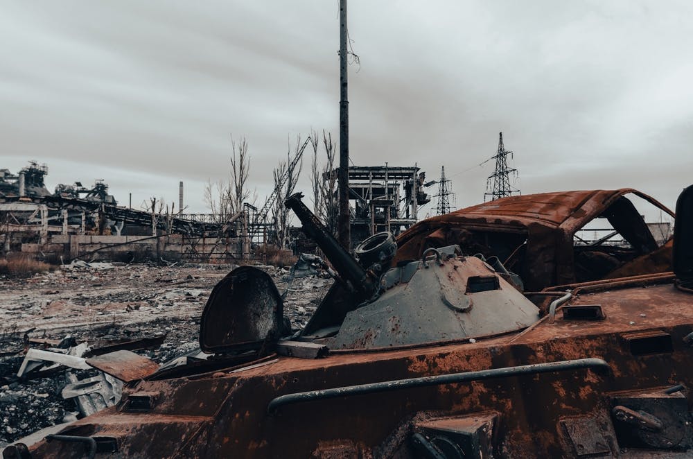 یک تانک سوخته و ساختمان‌های تخریب‌شده